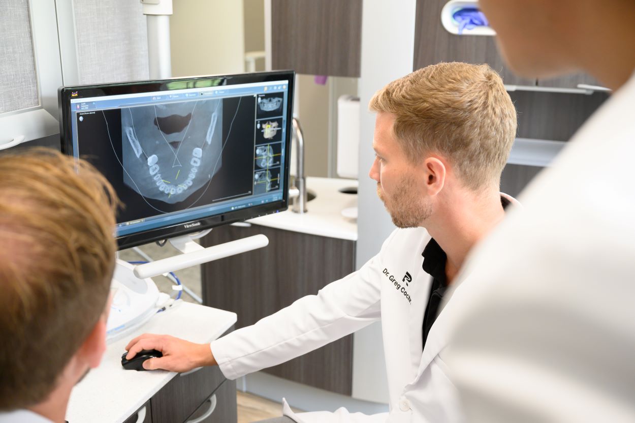 rivertown_dental_careers_team_doctors_review_patient_teeth rivertown_dental_careers_team_doctors_review_patient_teeth